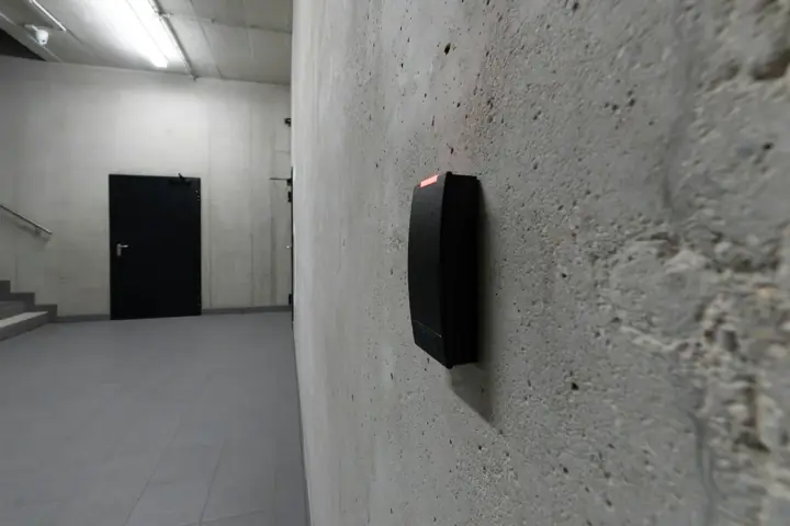 Card reader mounted beside a secured commercial door