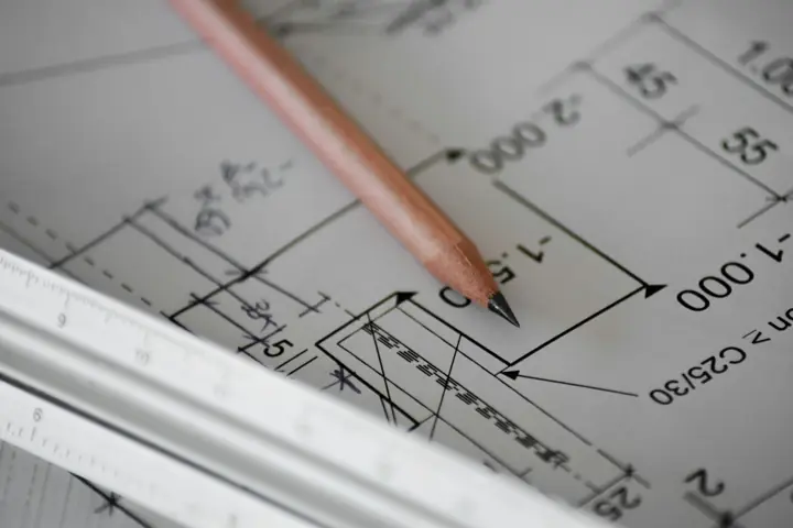 Pencil and ruler on construction blueprints